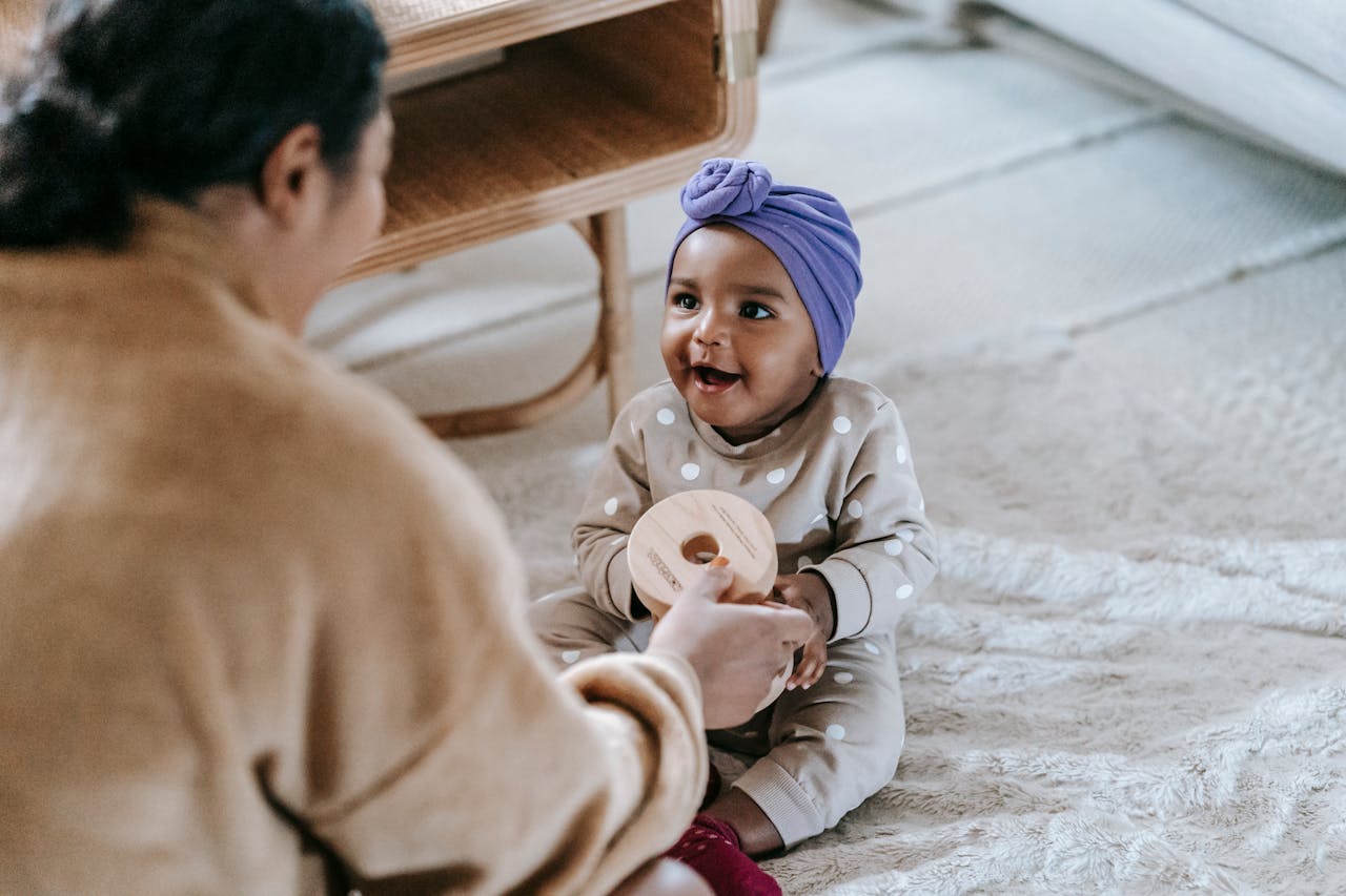 A happy mother and baby playing together at home, symbolizing warmth and love.